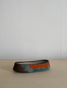 Sea green and flame orange boat
